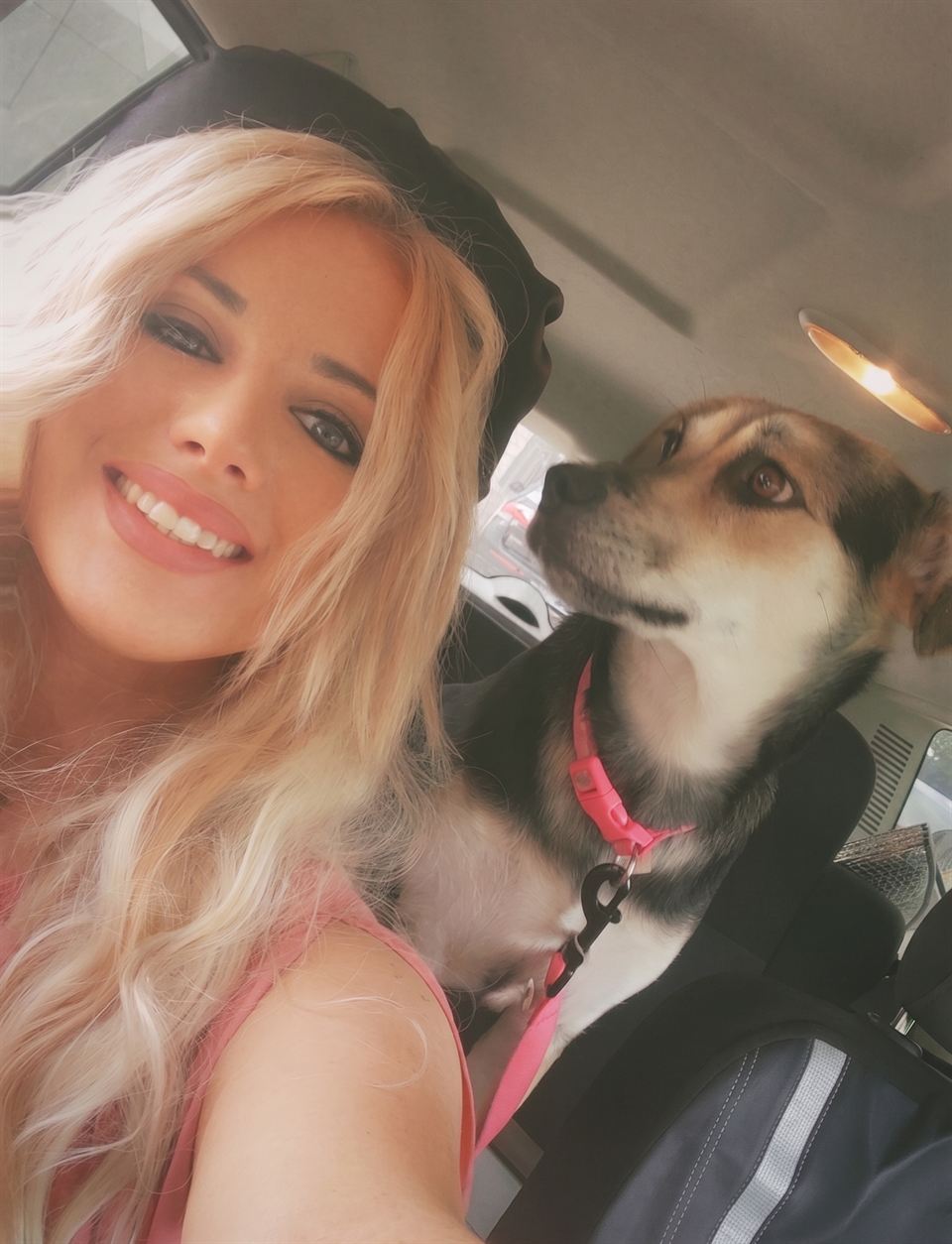 Kailey Wolfen of Austin, Texas, founder of Wolfen Clean Co., smiling in a selfie with her dog